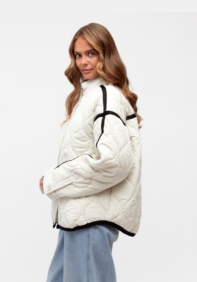 Milano Puffer Jacket Label of Love — side view of quilted relaxed fit puffer jacket with contrast black detailing