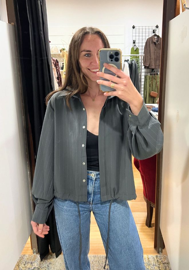 Little Lies Penelope Tie Bomber Shirt — front view of tie bomber shirt styled open as a layer over a casual outfit