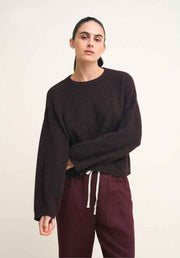 Otto Knit Rich Chocolate by Little Lies — three-quarter front view of rich chocolate cropped wool blend knit with crew neck and drawstring hem, styled with deep plum drawstring pants, shop in Australia at Kat and Ko Clothing