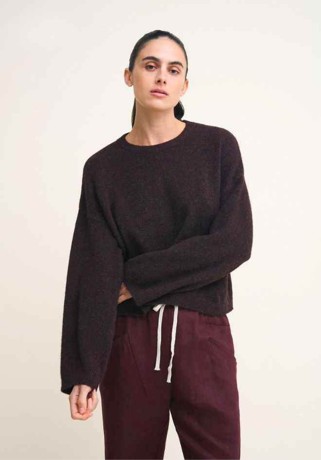 Otto Knit Rich Chocolate by Little Lies — three-quarter front view of rich chocolate cropped wool blend knit with crew neck and drawstring hem, styled with deep plum drawstring pants, shop in Australia at Kat and Ko Clothing