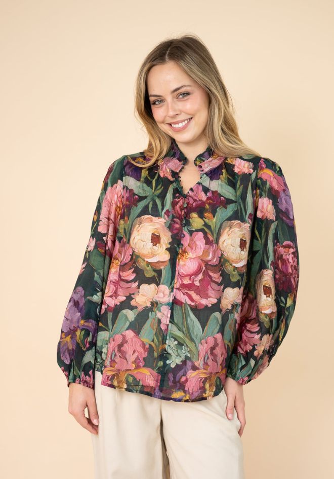 Estelle Print Blouse by Fria The Label — front view of floaty dark floral blouse with bold peony print, ruffled neckline and balloon sleeves, styled with white pants, available in Australia at Kat and Ko Clothing
