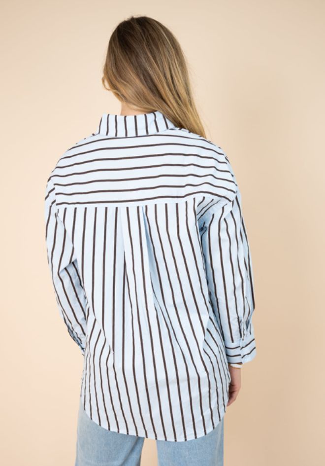 Billie Stripe Shirt Fria The Label — back view of relaxed blue and chocolate stripe button-up shirt with high-low hem, styled with light wash jeans, available in Australia at Kat and Ko Clothing