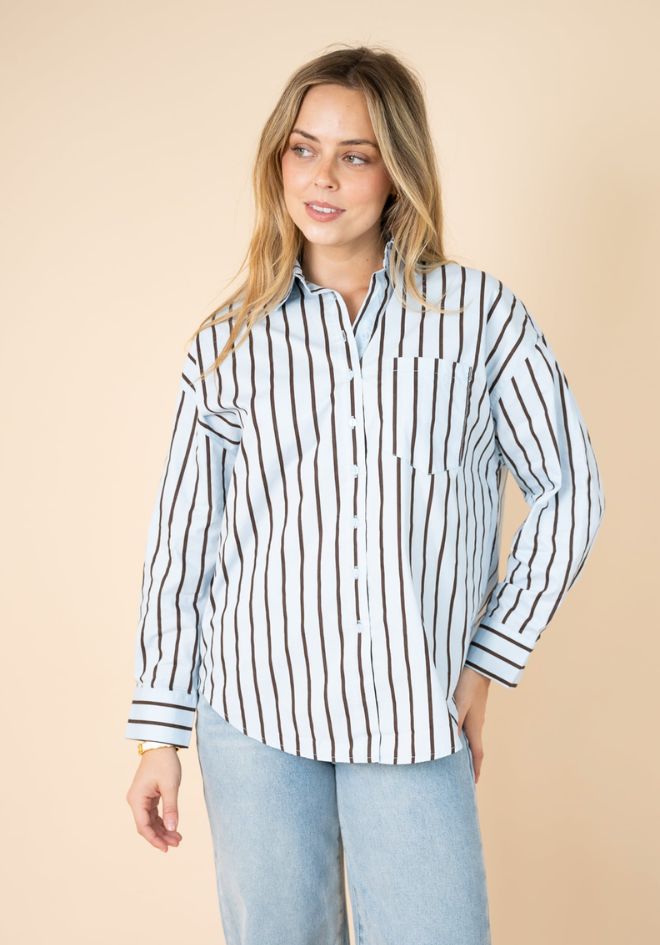 Fria The Label Billie Stripe Shirt — three-quarter front view of blue and chocolate stripe shirt with chest pocket and relaxed fit, styled with wide-leg light wash jeans, available in Australia at Kat and Ko Clothing