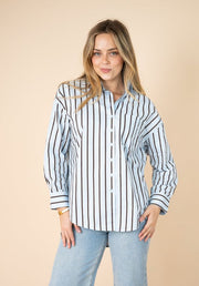 Billie Stripe Shirt by Fria The Label — front view of blue and chocolate stripe button-up shirt with collar and chest pocket, styled with light wash jeans, available in Australia at Kat and Ko Clothing
