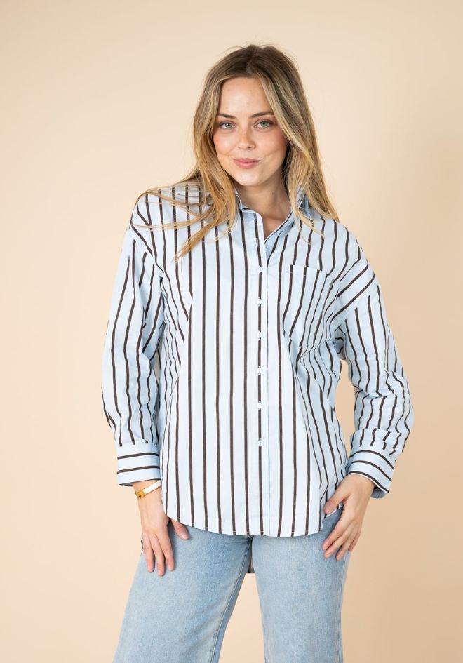 Billie Stripe Shirt by Fria The Label — front view of blue and chocolate stripe button-up shirt with collar and chest pocket, styled with light wash jeans, available in Australia at Kat and Ko Clothing