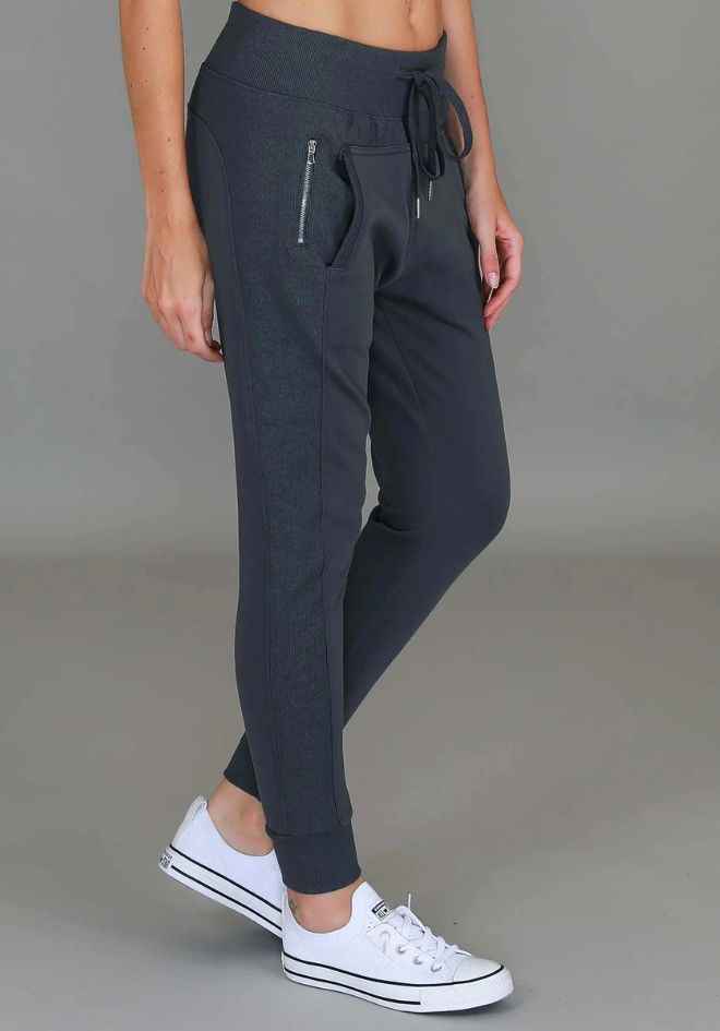 3rd Story The Label Byron Jogger Charcoal — angled side view of charcoal slim-fit jogger with contrast ribbed side panel, zip pocket and tapered ribbed ankle cuff, styled with white sneakers, shop in Australia at Kat and Ko Clothing