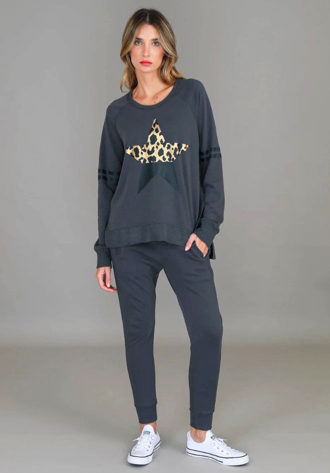 3rd Story The Label Ginger Leopard Star Sweater Charcoal — full-length front view of charcoal sweatshirt with gold leopard star print styled with matching Byron Jogger charcoal pants and white Converse sneakers, available in Australia at Kat and Ko Clothing