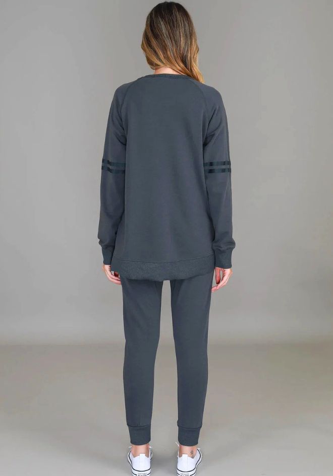 3rd Story The Label Ginger Leopard Star Sweater Charcoal — back view of relaxed charcoal sweatshirt with tonal stripe sleeve detail and curved hem, styled with matching charcoal jogger pants and white sneakers, available in Australia at Kat and Ko Clothing