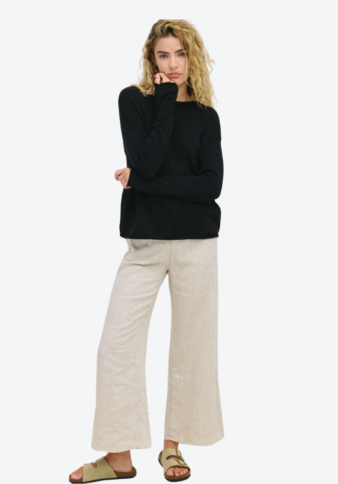 Little Lies Nellie Top in Black — full-length front view of relaxed cotton long sleeve top styled with linen wide-leg pants and sandals, shop in Australia