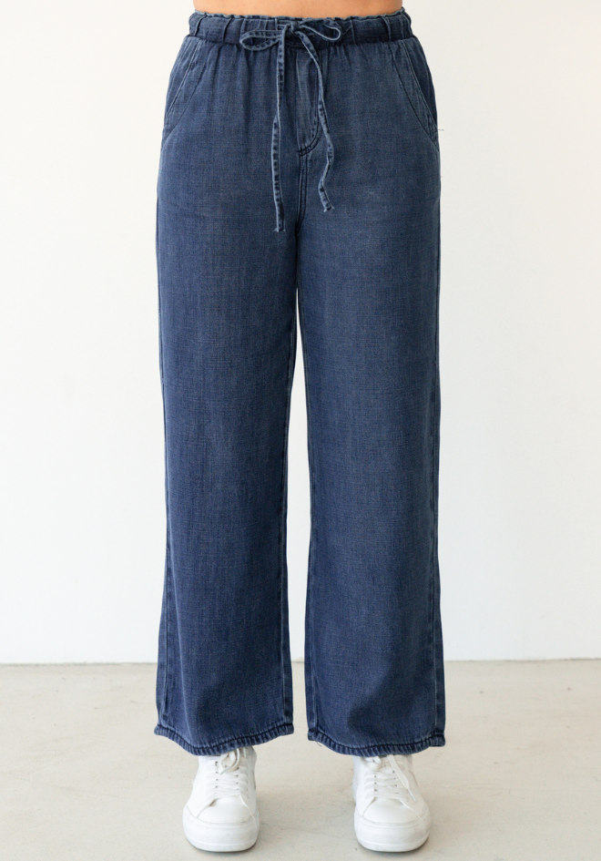 Label of Love Collette Chambray Pant — front detail of dark blue wide-leg lyocell pants with elastic drawstring waist, side pockets and frilled hem, shop in Australia at Kat and Ko Clothing