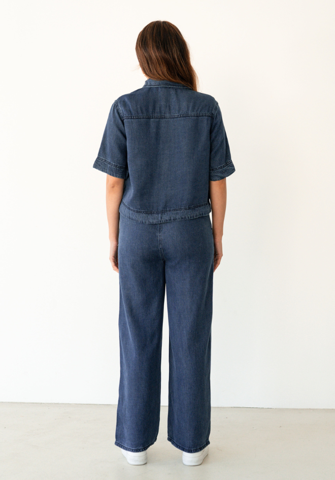 Label of Love Collette Chambray Pant — back view of dark blue lyocell wide-leg pants with full-length silhouette, styled with matching Collette Shirt, shop in Australia at Kat and Ko Clothing