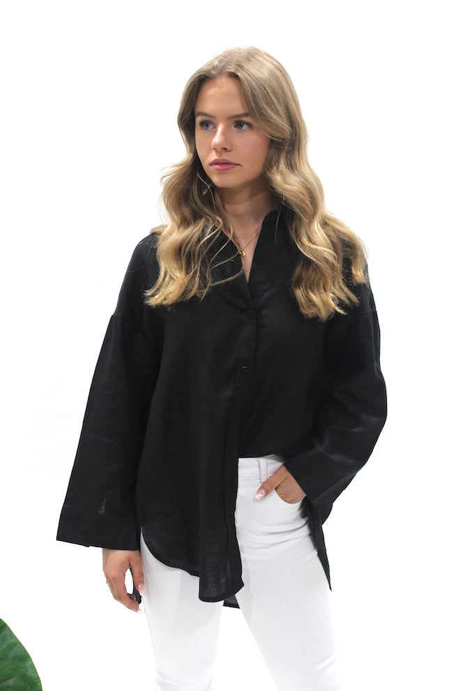 Little Lies Boyfriend Shirt in Black worn with white jeans, showing the relaxed fit and high-low hem