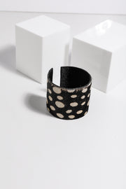 Amba Bangle by Holiday — black leather cuff bracelet with cream dot print, wide band boho-chic style, product flat lay on white background, shop in Australia at Kat and Ko Clothing