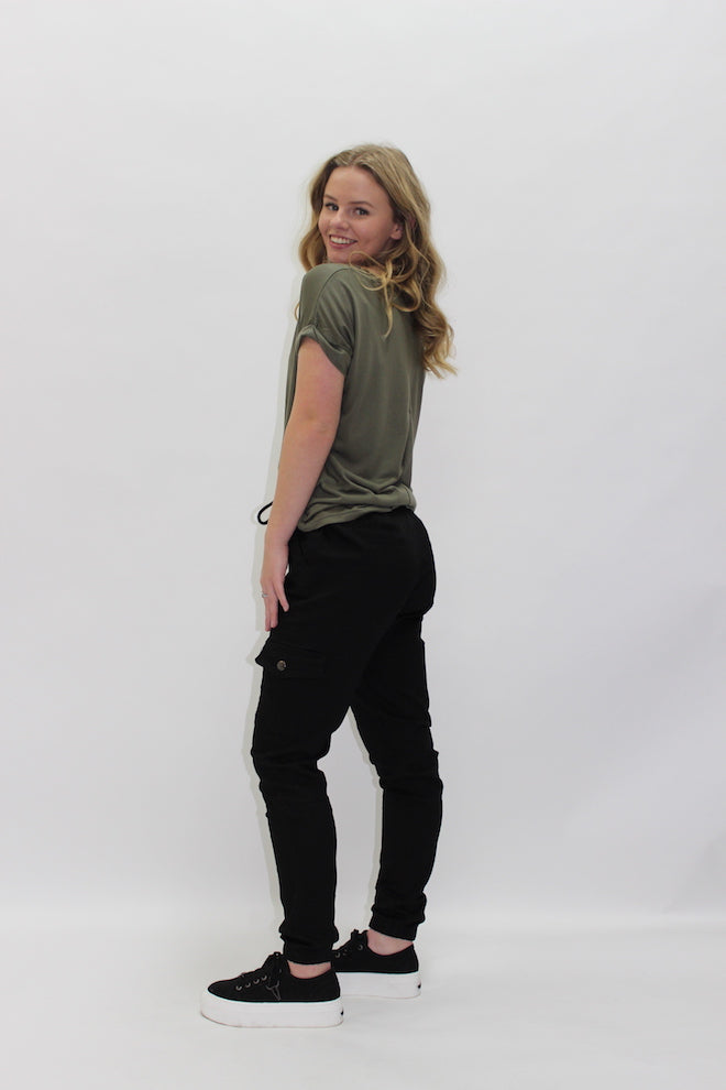 Wakee Jeans Chino Cargo Pants — side view of black cargo pants styled with an olive green tee and black sneakers, available in Australia at Kat and Ko Clothing