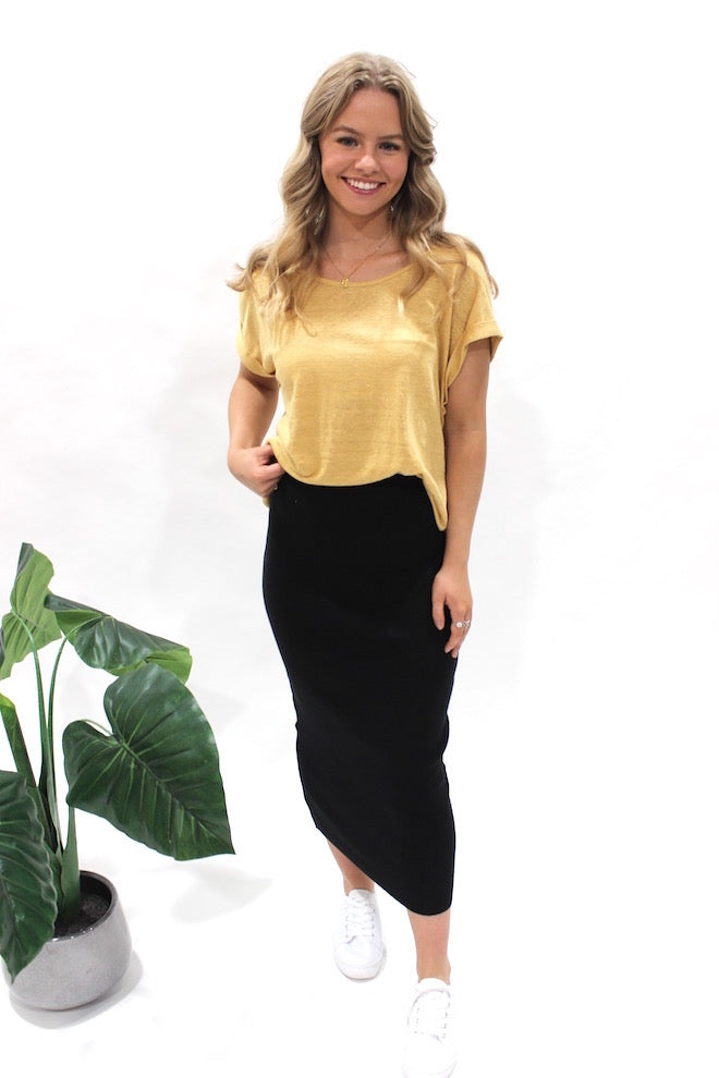 Silver Wishes Knit Pencil Skirt Black — front view of black ribbed midi skirt styled with a mustard tee and white sneakers, shop in Australia at Kat and Ko Clothing